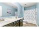 Bathroom with double sink vanity, floral shower curtain, and blue walls at 1905 Yellow Daisy Dr, Matthews, NC 28104