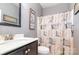 Cozy bathroom featuring a stylish vanity, toilet, mirror and shower with decorative curtain at 1905 Yellow Daisy Dr, Matthews, NC 28104