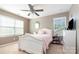 Bedroom featuring a ceiling fan, a double window, and pink beddings at 1905 Yellow Daisy Dr, Matthews, NC 28104