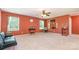 Large bonus room with neutral carpet, seating area, ample natural light, and ceiling fan at 1905 Yellow Daisy Dr, Matthews, NC 28104