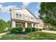 Inviting two-story home with a charming front porch and lush landscaping at 1905 Yellow Daisy Dr, Matthews, NC 28104