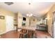 Open-concept living room with hardwood floors, fireplace, large windows, and ceiling fan at 1905 Yellow Daisy Dr, Matthews, NC 28104