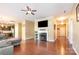 Cozy living room with hardwood floors, fireplace, ceiling fan, and open floor plan at 1905 Yellow Daisy Dr, Matthews, NC 28104