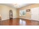 Sunlit living room with gleaming hardwood floors and neutral walls at 1905 Yellow Daisy Dr, Matthews, NC 28104