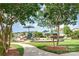 Community playground with lush landscaping, a paved pathway, and various play structures at 1905 Yellow Daisy Dr, Matthews, NC 28104