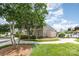 Community pool area showcasing a clubhouse, fenced pool, and well-maintained landscaping at 1905 Yellow Daisy Dr, Matthews, NC 28104