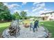 Expansive backyard featuring a fire pit, seating area, in-ground pool, and lush landscaping at 205 Wingate Dr, Stanley, NC 28164