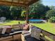 Inviting backyard featuring a pool, playground, and covered deck with comfortable seating at 205 Wingate Dr, Stanley, NC 28164