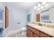 Bathroom with granite vanity top, wood cabinets, and neutral tile at 205 Wingate Dr, Stanley, NC 28164