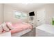 Inviting bedroom with soft pink bedding, built-in storage, and natural light at 205 Wingate Dr, Stanley, NC 28164