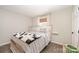 Bedroom features a queen bed, cozy decor, and ample natural light at 205 Wingate Dr, Stanley, NC 28164