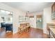 Charming dining area featuring wood table and benches and a view into the living room at 205 Wingate Dr, Stanley, NC 28164