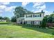 Charming two-story home featuring a lush lawn and classic architectural style at 205 Wingate Dr, Stanley, NC 28164
