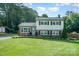 Charming two-story home with well-manicured lawn, brick accents, and lush landscaping creating curb appeal at 205 Wingate Dr, Stanley, NC 28164