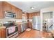 Functional kitchen with wooden cabinets, stainless steel appliances, and hardwood flooring at 205 Wingate Dr, Stanley, NC 28164