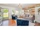 Stylish living room boasts modern furniture, wood accent wall, and ample natural light, creating a cozy space at 205 Wingate Dr, Stanley, NC 28164