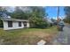 Exterior shot of a small, weathered home with boarded up windows and overgrown foliage at 210 Mahan Sw St, Concord, NC 28025
