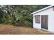Exterior shot of a small, weathered home with boarded up windows and overgrown foliage at 210 Mahan Sw St, Concord, NC 28025
