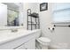 Bright bathroom with white vanity, new toilet and decorative shelf at 2117 Yadkin Ave, Charlotte, NC 28205