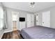 Bedroom with closet and en-suite bathroom, modern ceiling light and hardwood floors at 2117 Yadkin Ave, Charlotte, NC 28205