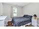 Cozy bedroom with a decorative gray comforter, white dresser, and a bright window at 2117 Yadkin Ave, Charlotte, NC 28205