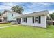 Quaint single-story home with a well-maintained lawn, black shutters, and neat landscaping at 2117 Yadkin Ave, Charlotte, NC 28205