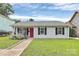 Charming single-story home featuring a red front door, black shutters and sidewalk to entry at 2117 Yadkin Ave, Charlotte, NC 28205