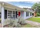 Cozy front porch featuring outdoor seating, a bright red door, and charming black shutters at 2117 Yadkin Ave, Charlotte, NC 28205