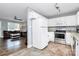 Bright kitchen featuring white cabinetry, stainless steel appliances, and an adjacent living room at 2117 Yadkin Ave, Charlotte, NC 28205
