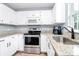 Efficient kitchen with stainless steel appliances and white cabinets offering plenty of storage at 2117 Yadkin Ave, Charlotte, NC 28205