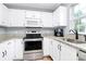 Modern kitchen with stainless steel appliances, granite counters, and ample cabinet space at 2117 Yadkin Ave, Charlotte, NC 28205