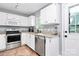 Well-equipped kitchen with stainless steel appliances, granite countertops, and white cabinetry at 2117 Yadkin Ave, Charlotte, NC 28205