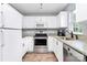 Bright kitchen featuring stainless steel appliances, granite counters, and a window for natural light at 2117 Yadkin Ave, Charlotte, NC 28205