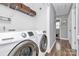 Convenient laundry room with modern Samsung washer and dryer, as well as overhead storage at 2117 Yadkin Ave, Charlotte, NC 28205