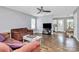Open-concept living room with hardwood floors, a ceiling fan, and seamless flow into the dining area at 2117 Yadkin Ave, Charlotte, NC 28205