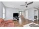 Bright living room with hardwood floors, a ceiling fan, and an adjacent dining area at 2117 Yadkin Ave, Charlotte, NC 28205