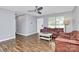 Cozy living room featuring hardwood floors, a ceiling fan, and natural light from a window at 2117 Yadkin Ave, Charlotte, NC 28205