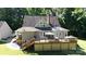 Backyard featuring a spacious deck with outdoor seating, mature trees and a neatly manicured lawn at 2168 Sunset Cir, Fort Mill, SC 29715