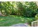 Expansive backyard with lush green grass and mature trees, perfect for outdoor activities and relaxation at 2168 Sunset Cir, Fort Mill, SC 29715
