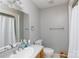 Bathroom featuring a sink, mirror, toilet, and shower with gray walls and a white shower curtain at 2168 Sunset Cir, Fort Mill, SC 29715