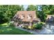 Aerial view of a beautiful home with mature trees, a manicured lawn, a porch, and a detached garage at 2168 Sunset Cir, Fort Mill, SC 29715