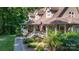 A beautiful home featuring an inviting wrap around porch with mature landscaping and an American flag at 2168 Sunset Cir, Fort Mill, SC 29715