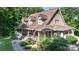 Charming two-story home featuring a welcoming front porch, American flag, and beautifully landscaped yard at 2168 Sunset Cir, Fort Mill, SC 29715