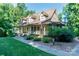 Beautifully landscaped home with a wrap-around porch, complemented by lush greenery at 2168 Sunset Cir, Fort Mill, SC 29715