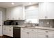 Bright kitchen featuring white cabinets, granite countertops, and stainless steel appliances at 2168 Sunset Cir, Fort Mill, SC 29715
