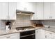 Modern kitchen with white cabinets, granite countertops, and stainless steel appliances at 2168 Sunset Cir, Fort Mill, SC 29715