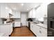 Modern kitchen featuring white cabinets, granite countertops, and stainless steel appliances at 2168 Sunset Cir, Fort Mill, SC 29715