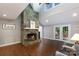 Bright living room boasts a floor-to-ceiling stone fireplace and ample natural light from French doors at 2168 Sunset Cir, Fort Mill, SC 29715