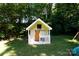 Playhouse in the backyard with a sliding barn door and bench at 2168 Sunset Cir, Fort Mill, SC 29715