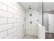 Modern walk-in shower with white subway tile and convenient bench seating at 2168 Sunset Cir, Fort Mill, SC 29715